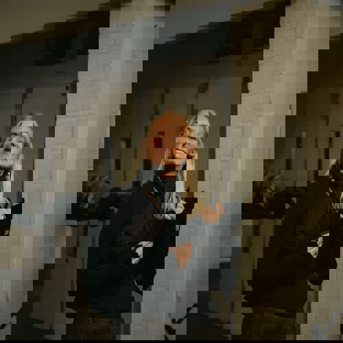 Production manager and 1st Assistant Director smiling at the camera on set