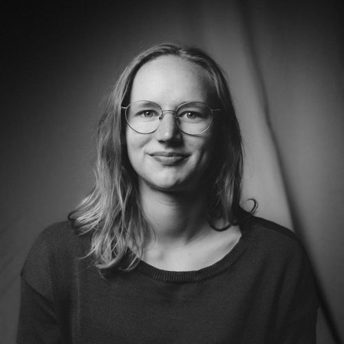 Young woman in a studio setting smiling at the camera